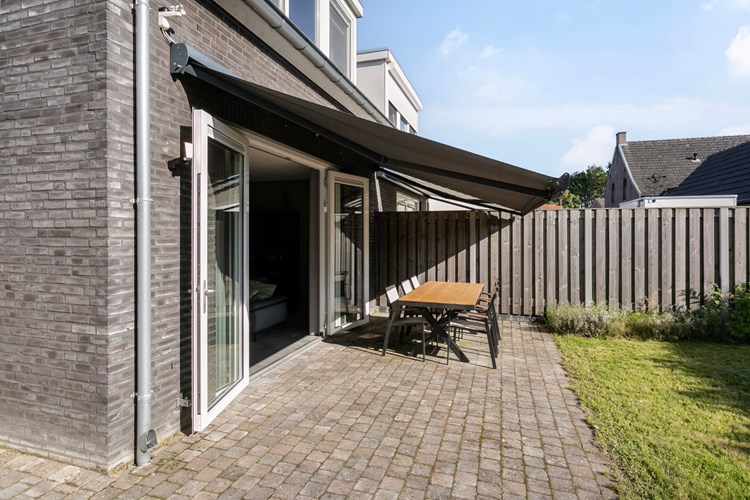 Direct aan de woning bevindt zich een beklinkerd terras met een elektrisch te bedienen zonneluifel met een zon-/windsensor. 