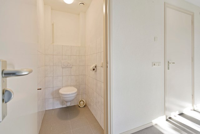 Op de verdieping is naast de badkamer een aparte toiletruimte met vrijhangend toilet.