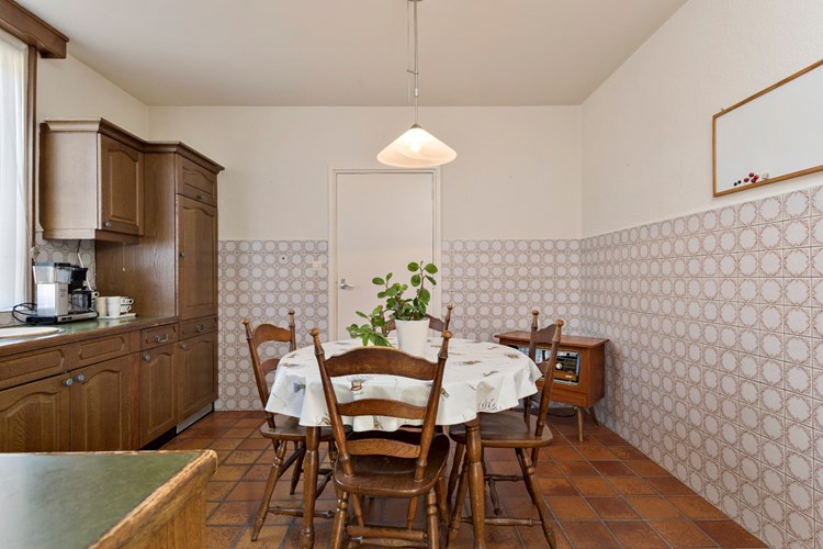 De keuken is voorzien van een tegelvloer, gedeeltelijk betegelde wanden en een stucwerk plafond. 