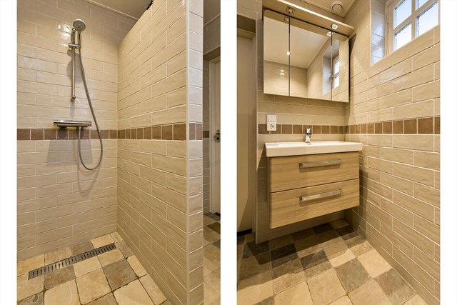 De badkamer is voorzien van een inloopdouche en badmeubel en is afgewerkt met mooi, eigentijds tegelwerk.