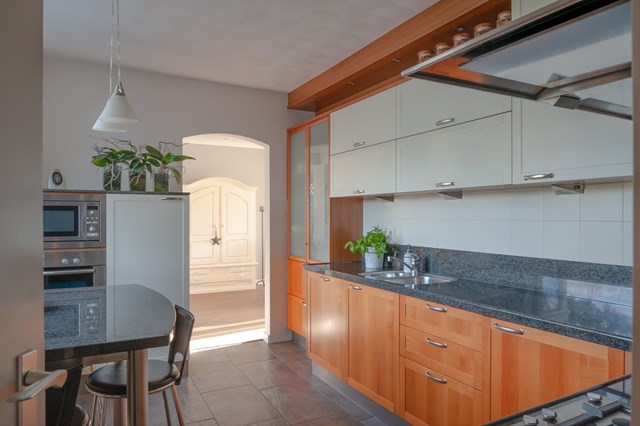 De moderne keuken die u bereikt via zowel de woonkamer als de berging is van alle gemakken voorzien.