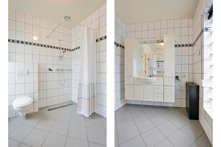 De badkamer is voorzien van een groot badmeubel met vaste wastafel, een spiegel en kastruimte. Verder een wandcloset en een inloopdouche. 