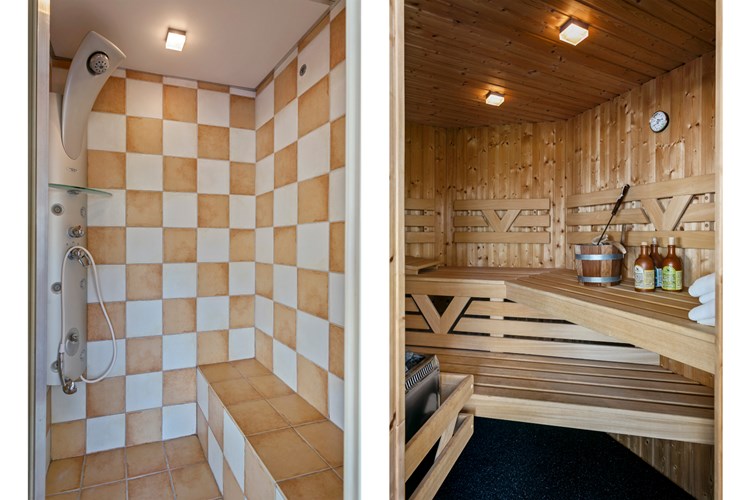 Vanuit de wellness ruimte toegang tot een vaste saunacabine en en aparte stoomcabine met een douche.